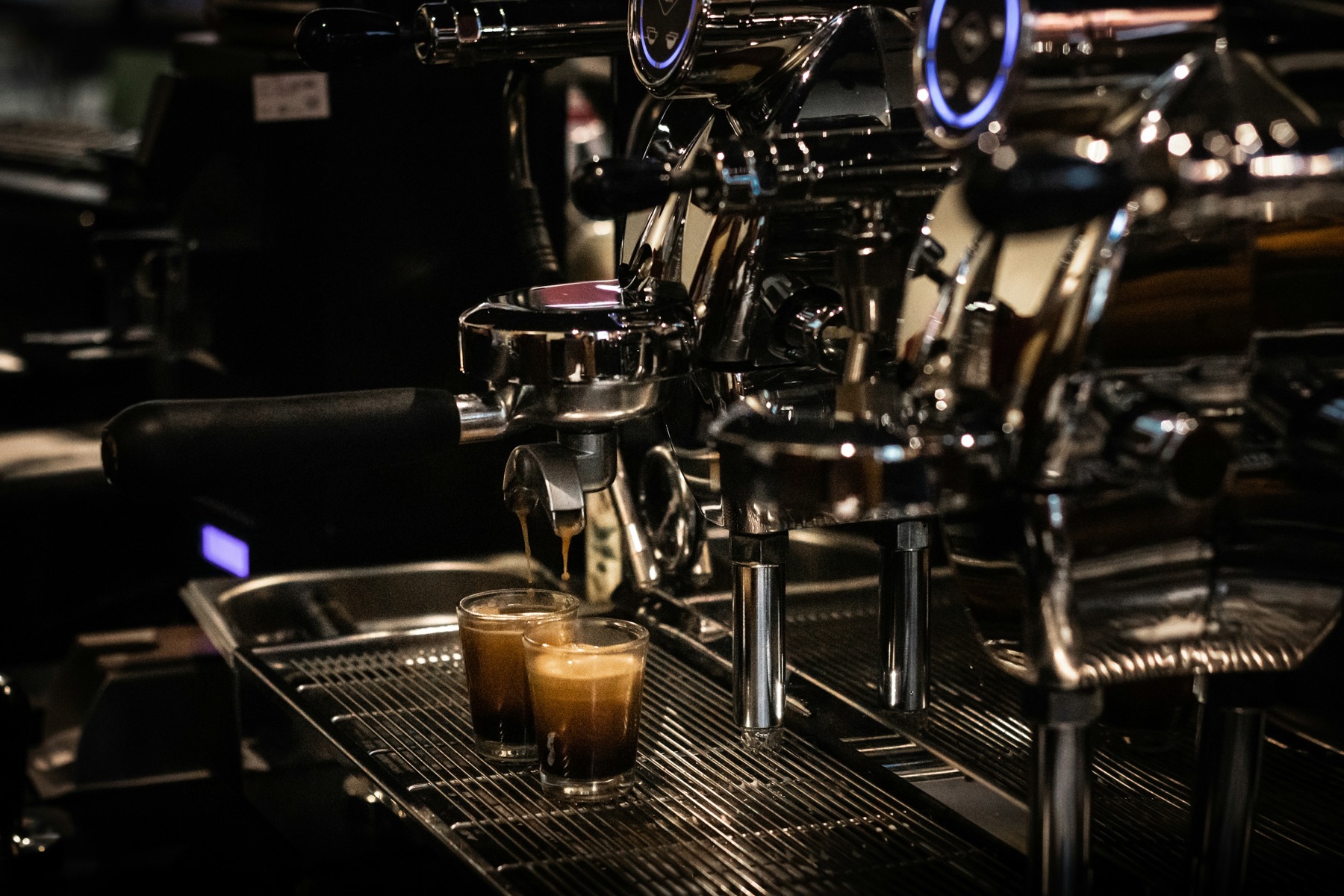Commercial espresso machine in a dark café
